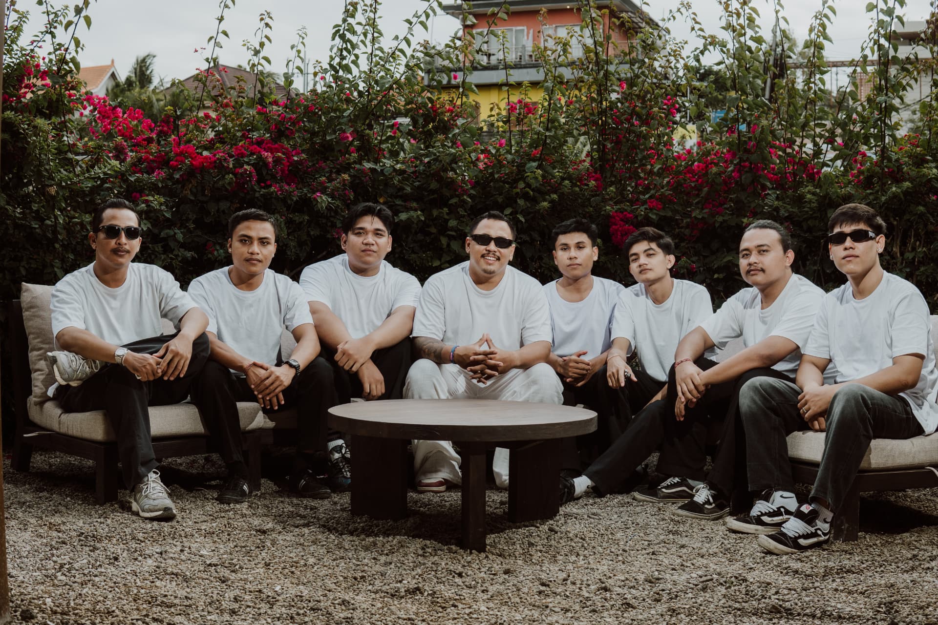 The TAMAN team together in the garden in front of bougainvillea