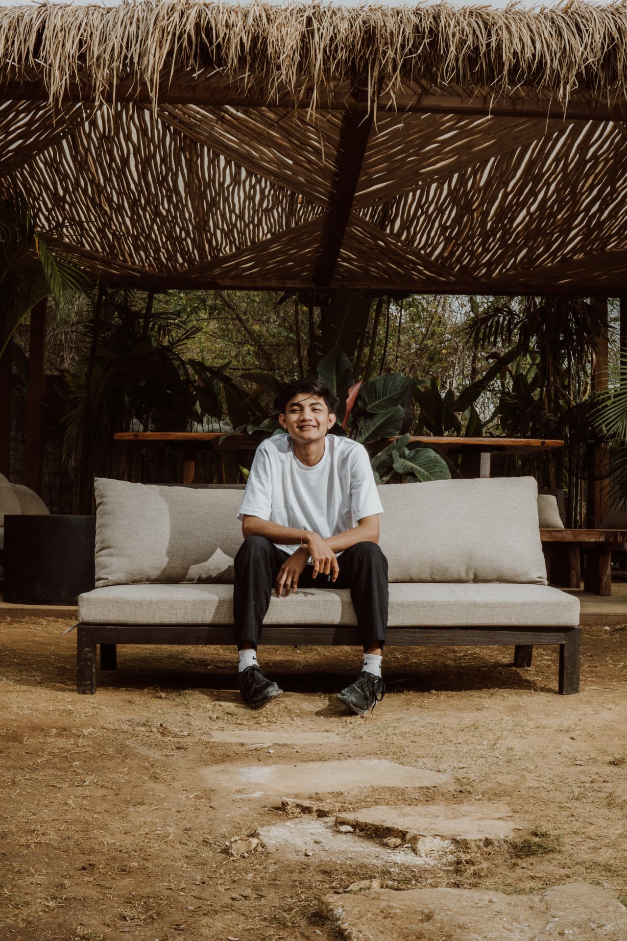Member of the TAMAN team relaxing in the garden lounge