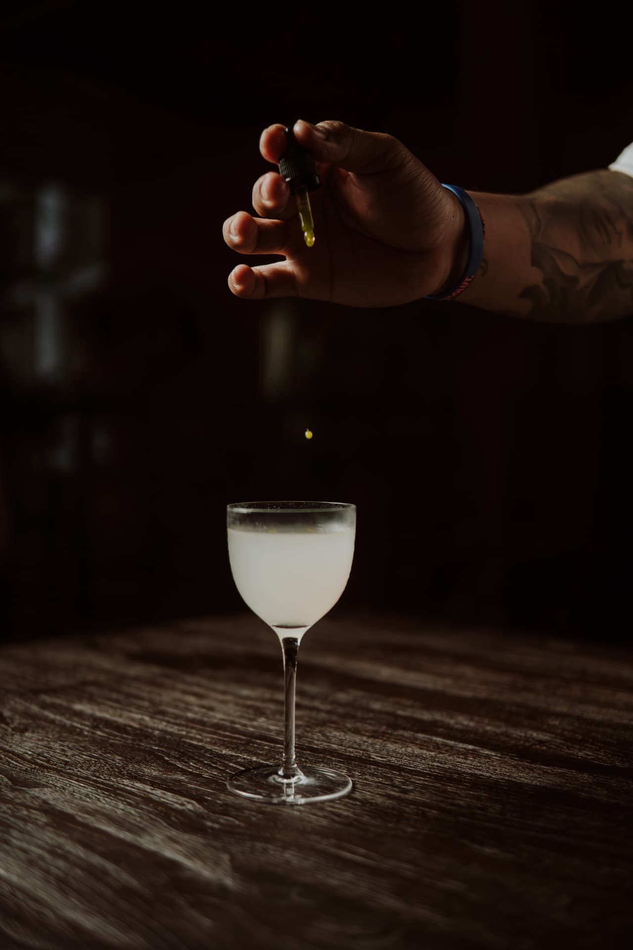 Bartender adding the final drops to a cocktail at TAMAN