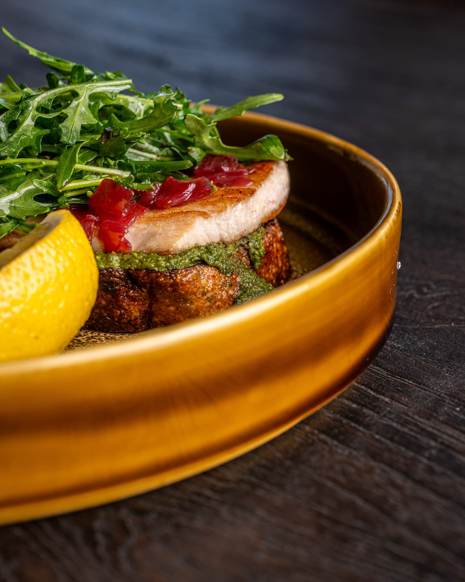 Crispy dish with arugula, lemon and fresh garnish at TAMAN